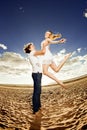 Happiness man holding a woman on the beach. Couples in love by a