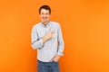 Happiness man pointing finger at copy space and toothy smile. Royalty Free Stock Photo