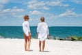 Two happy girls in bikini on the beach. Best friends walking on the beach Royalty Free Stock Photo