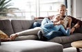 Happiness is a quiet afternoon at home. a mature couple reading a book together while relaxing on the sofa at home. Royalty Free Stock Photo