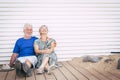 Happiness in retired lifestyle people with caucasian senior aged couple sitting and smiling happy on the floor hugging together