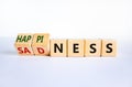 Happiness or sadness symbol. Turned cubes and changed the word `sadness` to `happiness`. Beautiful white background. Business,