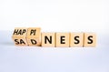 Happiness or sadness symbol. Turned cubes and changed the word `sadness` to `happiness`. Beautiful white background. Business,