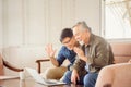 Happiness senior asian father and adult son using laptop talking on video call in living room Royalty Free Stock Photo