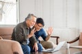 Happiness senior asian father and adult son using laptop talking on video call in living room Royalty Free Stock Photo