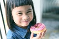 Happiness smiling face of asian children with sweet donut in han Royalty Free Stock Photo