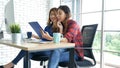 Happiness two women working together confident team meeting in office desk. Team business partners working with computer laptop Royalty Free Stock Photo