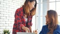 Happiness two women working together confident team meeting in office desk. Team business partners working with computer laptop Royalty Free Stock Photo