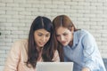 Happiness two women working together confident team meeting in office desk. Team business partners working with computer laptop Royalty Free Stock Photo