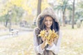 Happiness woman with authumn leaves on hands in the park. Royalty Free Stock Photo