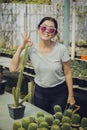 Happiness woman standing in cactus green house