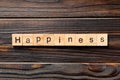 Happiness word written on wood block. Happiness text on wooden table for your desing, Top view concept Royalty Free Stock Photo