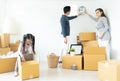 Happiness young Asian family unpacking cardboard boxes and moving into a new home.Moving house day and express delivery concept Royalty Free Stock Photo