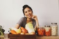 Happiness of an young asian woman preparing fermented food and eating kimchi in a glass jar with various kinds of fresh vegetables Royalty Free Stock Photo