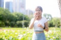 Happiness young asian woman standing and talking on smart phone in the park, girl relaxation and receiving smartphone. Royalty Free Stock Photo