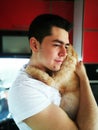 Happiness. Cat with Young Man. Orange Persian Cat. Lover Man, Hugging and Cuddling his Happy Domestic Cat Pet. Love to the animals