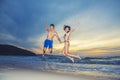 Happiness young couple jumping with happy on the beach at sunset. Vacation and freedom travel. Love, wedding and valentine concept Royalty Free Stock Photo