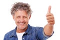 Happiness is yours for the taking. Studio shot of a positive mature man giving thumbs up isolated on white.