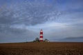 Happisburgh Lighthouse on the top of a hill on the coast of Norfolk Royalty Free Stock Photo