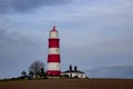 Happisburgh Lighthouse on the top of a hill on the coast of Norfolk Royalty Free Stock Photo