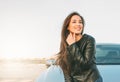 Happpy beautiful charming brunette long hair young asian woman in black leather jacket near her car Royalty Free Stock Photo