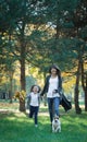 Happy abstract: mother and daughter run in city park