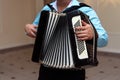 Happy accordion musician playing at wedding reception, hand on h Royalty Free Stock Photo