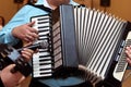 Happy accordion musician playing at wedding reception, hand on h Royalty Free Stock Photo