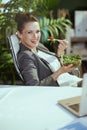 happy accountant woman in green office eating salad Royalty Free Stock Photo