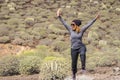 Happy active adult woman jump with happiness and fun during outdoor trekking leisure activity in the natural desert outdoors -