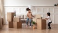 Happy active african kids playing with boxes on moving day Royalty Free Stock Photo