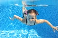 Happy active child swims underwater in pool Royalty Free Stock Photo