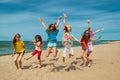 Happy active children jumping on the beach