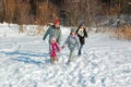 Happy family walks in winter, having fun and playing with snow outdoors on holiday weekend Royalty Free Stock Photo