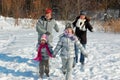 Happy family walks in winter, having fun and playing with snow outdoors on holiday weekend