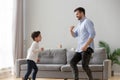 Happy dad and kid son dancing together in living room Royalty Free Stock Photo