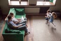 Happy kids playing together while parents using laptop, top view Royalty Free Stock Photo