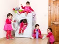 Happy active little child using washing machine