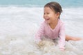 Happy active little girl playing and having fun on the beach sand Royalty Free Stock Photo
