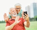 woman man outdoor senior couple phone online communication senior call video elderly phone mobile smartphone Royalty Free Stock Photo