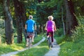 Happy and active senior couple riding bicycles outdoors in the park Royalty Free Stock Photo