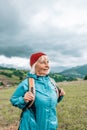 Happy active senior tourist woman listening to music in outdoor leisure trip admiring the landscape feeling inspired by Royalty Free Stock Photo