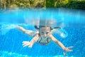 Happy active underwater child swims in pool Royalty Free Stock Photo
