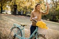 Happy active woman riding bicycle in autumn park Royalty Free Stock Photo