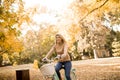 Happy active woman riding bicycle in autumn park Royalty Free Stock Photo