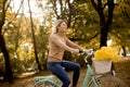 Happy active woman riding bicycle in autumn park Royalty Free Stock Photo