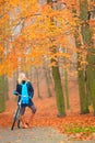 Happy active woman riding bike in autumn park. Royalty Free Stock Photo