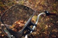 Happy active young woman riding bicycle in autumn park Royalty Free Stock Photo