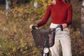 Happy active young woman riding bicycle in autumn park Royalty Free Stock Photo