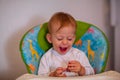 Happy adorable boy eating delicious chocolate Royalty Free Stock Photo